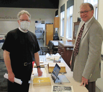 Pastor Brian Vasey and Church Archivist, Gary Weber, look at some of the historical records related to St. Mark’s Lutheran Church.